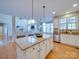 Bright kitchen island with granite countertops, stainless steel appliances, and hardwood floors at 1708 Aringill Ln, Matthews, NC 28104