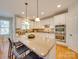 Bright kitchen with granite counters, stainless appliances, double ovens, island with seating at 1708 Aringill Ln, Matthews, NC 28104