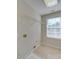 Well-lit laundry room featuring storage shelves and tile flooring at 1708 Aringill Ln, Matthews, NC 28104