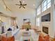 Bright living room with fireplace, hardwood floors, soaring ceilings and a ceiling fan at 1708 Aringill Ln, Matthews, NC 28104