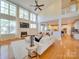 Bright living room with fireplace, hardwood floors, and soaring ceilings with large windows at 1708 Aringill Ln, Matthews, NC 28104