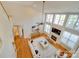 Aerial view of the living room with a fireplace and soaring ceilings and large windows at 1708 Aringill Ln, Matthews, NC 28104