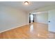 A view of the living room showcasing its hardwood floors and natural light at 1708 Aringill Ln, Matthews, NC 28104