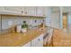 Built-in home office area has granite countertops, custom tile backsplash, and lots of natural light at 1708 Aringill Ln, Matthews, NC 28104