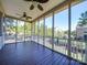 A screened porch features dark wooden flooring and offers an expansive backyard view at 1708 Aringill Ln, Matthews, NC 28104