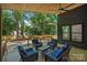 Inviting covered back deck with ceiling fan, outdoor seating and wooded backyard at 1711 Summey Ave, Charlotte, NC 28205