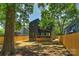 Spacious backyard with modern home, wooden fence, and lush trees at 1711 Summey Ave, Charlotte, NC 28205