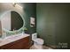 Modern bathroom with unique wall color, modern vanity and sink, with updated fixtures and design at 1711 Summey Ave, Charlotte, NC 28205