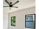 Light and airy bedroom with a ceiling fan and multiple windows providing ample natural light at 1711 Summey Ave, Charlotte, NC 28205