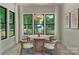 Dining area features a round table with modern chairs and large windows with green views at 1711 Summey Ave, Charlotte, NC 28205