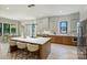 Open kitchen area featuring a large kitchen island with barstools, wooden cabinets, and stainless appliances at 1711 Summey Ave, Charlotte, NC 28205