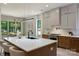 Stylish kitchen featuring a large island, modern cabinetry, stainless steel appliances, and bright lighting at 1711 Summey Ave, Charlotte, NC 28205