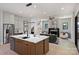 Open concept living space with large kitchen island, stainless appliances, and fireplace in the living room at 1711 Summey Ave, Charlotte, NC 28205