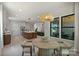 Open concept living space with kitchen island, dining area and living room with lots of windows at 1711 Summey Ave, Charlotte, NC 28205