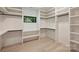 Large walk-in closet with window, custom shelving, and natural light at 1711 Summey Ave, Charlotte, NC 28205