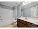 A guest bathroom provides a white tub with a shower and single sink vanity at 17916 Ragtop Day Ln, Cornelius, NC 28031