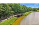 Scenic view of a pedestrian bridge over a tranquil waterway with lush greenery on either side at 17916 Ragtop Day Ln, Cornelius, NC 28031