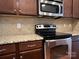 The kitchen features granite countertops, stainless steel appliances, and warm-toned cabinetry at 17916 Ragtop Day Ln, Cornelius, NC 28031
