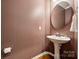 This powder room features a pedestal sink and hard wood floors at 17916 Ragtop Day Ln, Cornelius, NC 28031