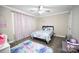 A cozy bedroom with a ceiling fan and a colorful rug and curtains at 1821 Sherrer Rd, York, SC 29745