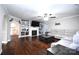 Inviting living room featuring hardwood floors, a cozy fireplace, and built-in shelving at 1821 Sherrer Rd, York, SC 29745