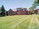This backyard has a lush green lawn at 200 Waterby Way, Matthews, NC 28104