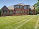 This backyard has a lush green lawn at 200 Waterby Way, Matthews, NC 28104