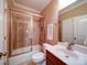 Bathroom featuring vanity with solid surface countertop, and tub-shower combination with glass doors at 200 Waterby Way, Matthews, NC 28104