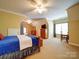 Large bedroom with hardwood furniture and a view of the neighborhood at 200 Waterby Way, Matthews, NC 28104