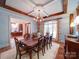 Formal dining room showcasing a chandelier, rich wood accents, and a view into the office at 200 Waterby Way, Matthews, NC 28104