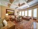 Inviting living room featuring a large rug, coffered ceilings, large windows and plenty of seating at 200 Waterby Way, Matthews, NC 28104