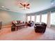 Cozy living room with plush leather seating and a large window showcasing natural light at 200 Waterby Way, Matthews, NC 28104