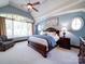 Bright main bedroom with tray ceilings, large windows, and sitting area at 200 Waterby Way, Matthews, NC 28104