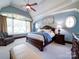 Bright main bedroom with tray ceilings, large windows, and sitting area at 200 Waterby Way, Matthews, NC 28104