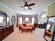 Spacious primary bedroom with carpet, bay window, ceiling fan, and ensuite bathroom at 200 Waterby Way, Matthews, NC 28104