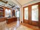 Home office boasting custom built-ins, hardwood floors, coffered ceiling, and elegant double door entry at 200 Waterby Way, Matthews, NC 28104