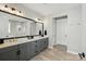 Modern bathroom with double vanity, gray cabinets, a large mirror, and sleek tiled flooring at 2062 Nellies Way, Fort Mill, SC 29715