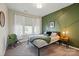 Bedroom features an accent wall, cozy reading chair, and ample natural light from the windows at 2062 Nellies Way, Fort Mill, SC 29715