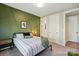 Stylish bedroom boasts a decorative green wall, plush bedding, and modern furnishings at 2062 Nellies Way, Fort Mill, SC 29715