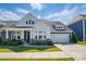 Charming two-story home with a manicured lawn, covered porch, and a two-car garage at 2062 Nellies Way, Fort Mill, SC 29715