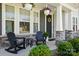 Inviting front porch features rocking chairs and hanging plants with a stylish stone base at 2062 Nellies Way, Fort Mill, SC 29715