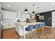 This open kitchen features a large granite island with stylish pendant lighting and stainless steel appliances at 2062 Nellies Way, Fort Mill, SC 29715