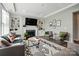 Cozy living room with fireplace, modern decor, and built in shelving at 2062 Nellies Way, Fort Mill, SC 29715