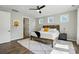 Brightly lit main bedroom offering three windows, rustic wood bed frame, ceiling fan and ensuite bath at 2062 Nellies Way, Fort Mill, SC 29715