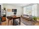 Bright home office with large windows, a comfortable seating area and plenty of workspace at 2062 Nellies Way, Fort Mill, SC 29715