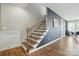 Elegant stairway with hardwood steps, black iron railings, and stylish wood floors at 2062 Nellies Way, Fort Mill, SC 29715