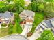 Beautiful aerial view of brick home and surrounding neighborhood, showcasing manicured lawns, mature trees, and lush greenery at 208 Mcduffie Ln, Fort Mill, SC 29715