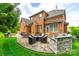 Spacious brick patio featuring an outdoor kitchen and dining area, and lush green landscaping at 208 Mcduffie Ln, Fort Mill, SC 29715