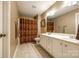 Beige bathroom featuring double sink vanity, tile floors, bronze hardware, and modern lighting at 208 Mcduffie Ln, Fort Mill, SC 29715