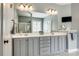 Bathroom featuring dual sinks, a large mirror, and updated fixtures at 208 Mcduffie Ln, Fort Mill, SC 29715